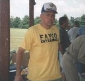 male local citizen wearing a yellow tee shirt with FAYCO logo